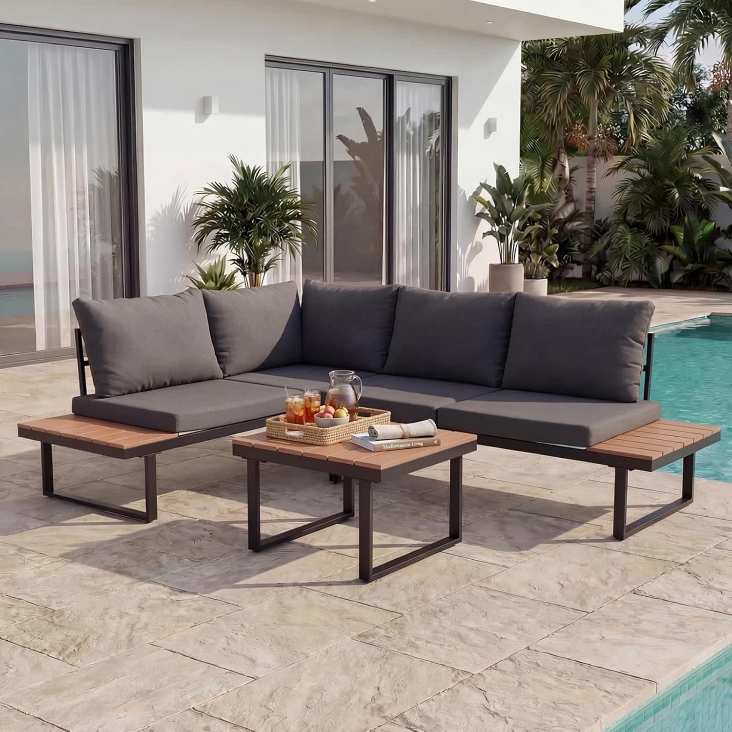 Moderne Outdoor-Lounge mit Sofa und Feuertisch im Garten bei Dämmerung